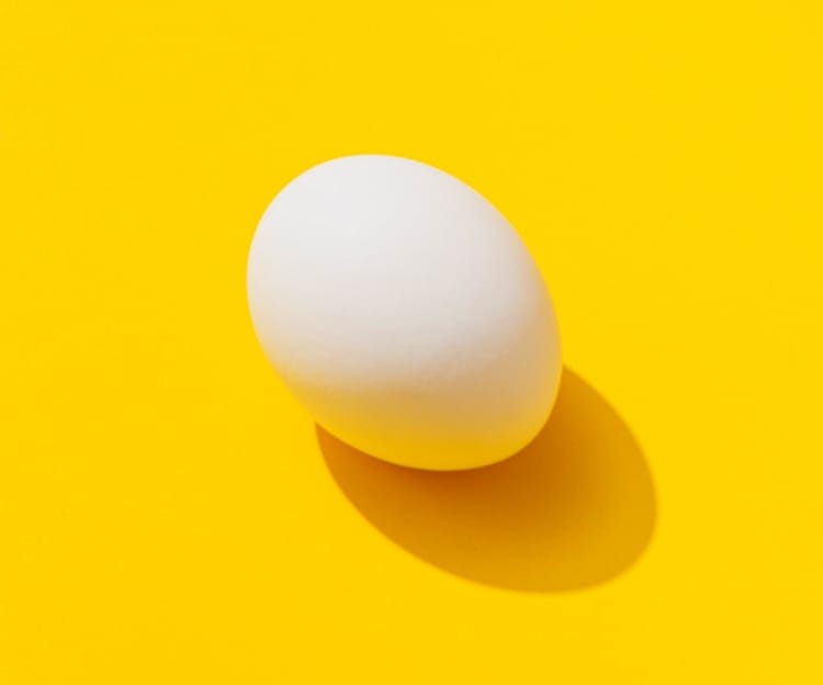 Transform your brand image, a white egg with a yellow background.